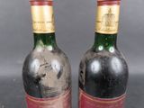 two bottles of wine are sitting next to each other on a table