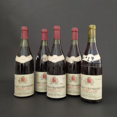 six bottles of wine are lined up in a row on a table
