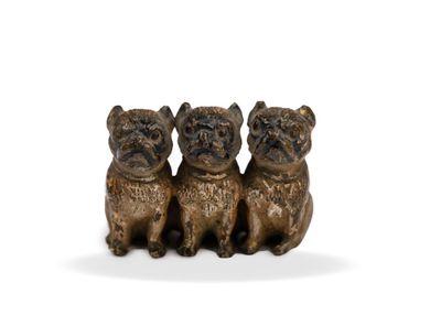 three bronze figurines of dogs sitting on top of each other