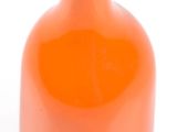 an orange vase that is sitting on a white surface