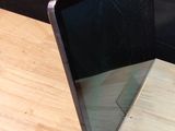 a laptop computer sitting on top of a wooden table
