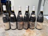 six bottles of wine wrapped in plastic sitting on top of a table