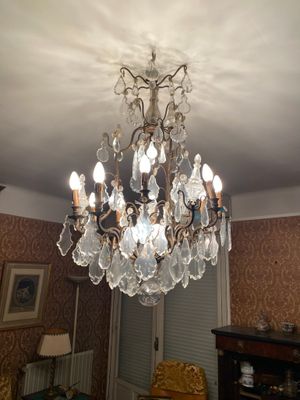 a crystal chandelier hanging from the ceiling in a living room