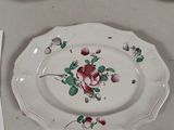 three plates with flowers on them on a table