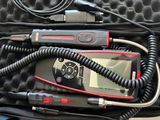 a case with a remote, a microphone, and a cell phone in it