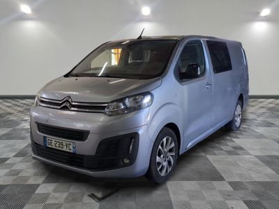 the silver van is parked on a checkered floor in a room