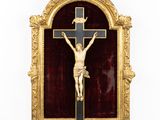 a gold framed crucifix with a cross on it