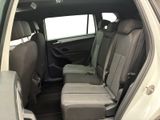 the back seats of a white car are empty and the passenger seats are empty