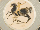 a plate with a picture of a man riding a horse
