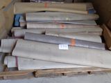 many rolls of paper sitting on a pallet in a warehouse