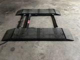 a close up of a metal platform in a garage
