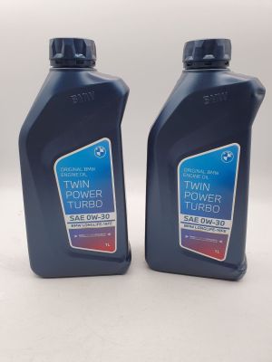 two bottles of twin turbo turbo oil on a white surface