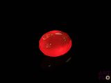an image of a glowing red apple on a black surface