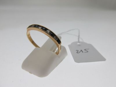 une bague en or sertie de diamants noirs, avec une étiquette indiquant son prix