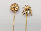 two gold tone pins with flowers and pearls on them