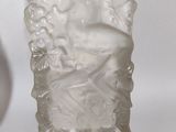 an old glass vase with a statue of a woman on it