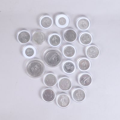 a pile of coins sitting on top of a white table