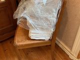 a wooden chair with a plastic bag on it in the corner of a room