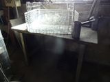 a metal basket sitting on top of a table in a room