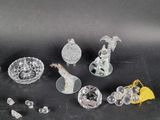 some glass figurines are sitting on a black surface