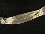 a close up of a belt with a silver buckle on it