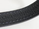 the black leather strap has a silver buckle on the end of it