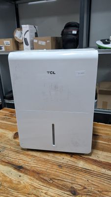 a small white air purifier on a wooden table
