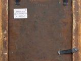 an old wooden picture frame with a label on it