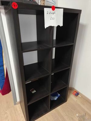 a black bookcase with a bunch of books on top of it