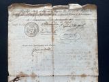 an old document with a stamp on it on a table