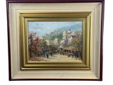 tableau à l'huile encadré représentant une scène de village avec une calèche