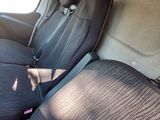 four seats in the back of a van that are empty
