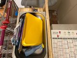 a sink with a yellow tray in it next to a calendar
