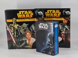 two star wars books are sitting next to each other on a white surface