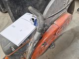 a moped that is sitting on the ground in the garage