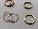 three gold rings and a gold ring with a diamond on top