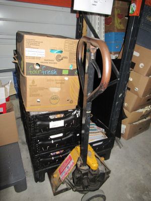 a stack of boxes and a pair of scissors on a cart