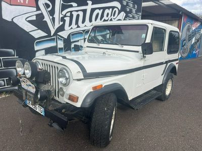 a white jeep that is parked in front of a building