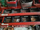 many bins of different types of screws on the shelf