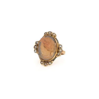 un gros plan sur une bague en or sur laquelle figure le portrait d'une femme