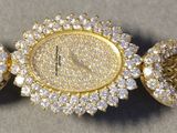 yellow metal bracelet with a gold clasp and a gold watch band