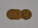 two gold coins sitting on top of each other on a white surface