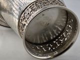 a silver cup that is sitting on a table