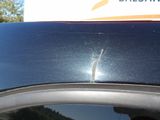 a car with a broken windshield and a broken window