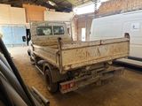 a white truck that is parked in a garage
