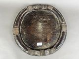 a silver plate with a design on it on a table