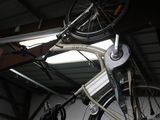 a bike hanging from the ceiling in a garage