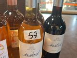 several bottles of wine are lined up on a table