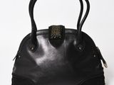 black leather handbag with gold hardware detail