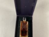 perfume bottle in a purple box on a white surface